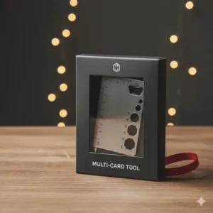 The multipurpose tool card presented neatly in its sleek, minimalist retail packaging, suggesting its use as a compact gift.