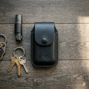 A minimalist black leather gerber multi tool pouch with a vertical belt loop.
